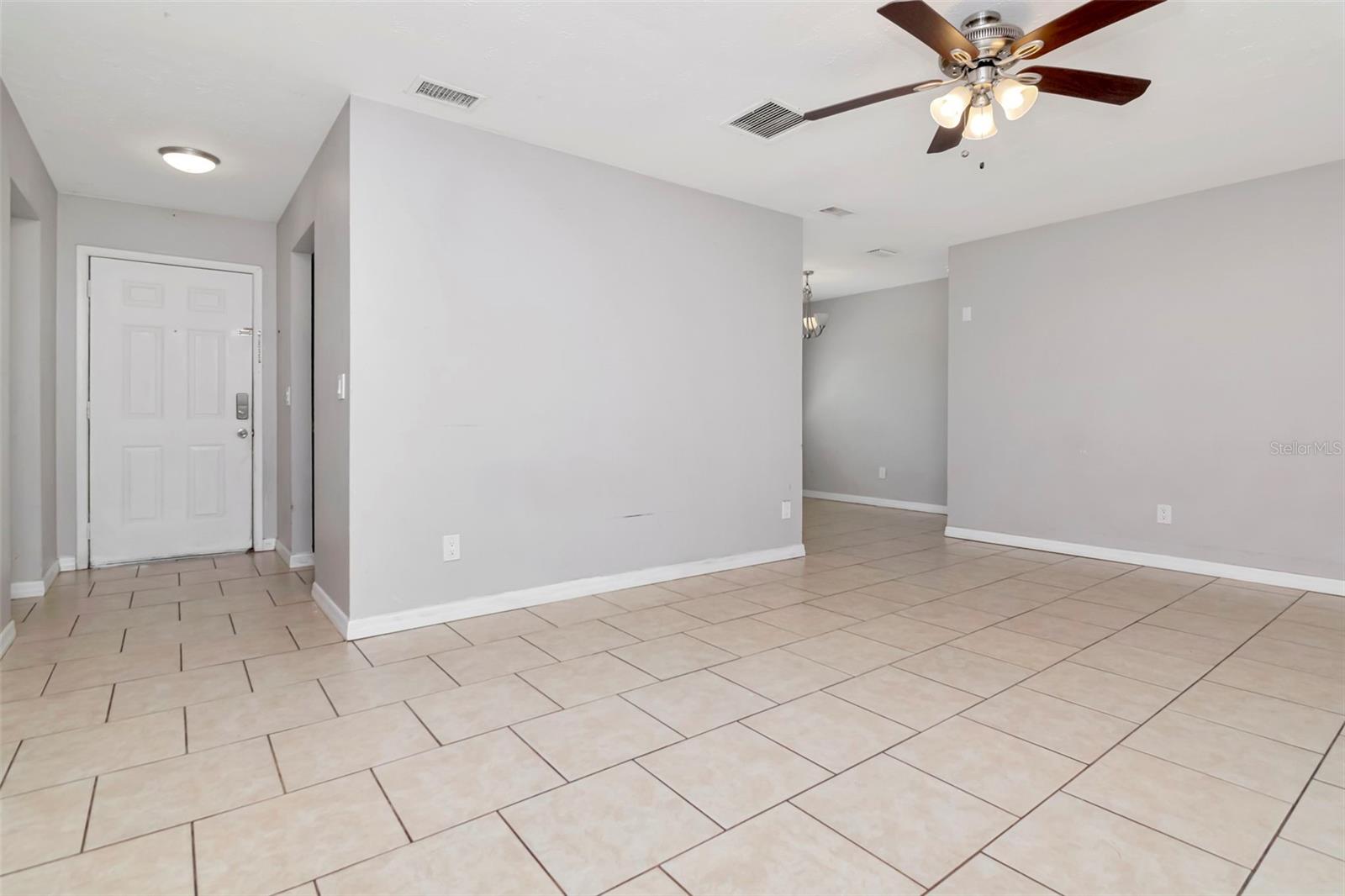 Front door and foyer from the living room. The dining room is the distance to the right.