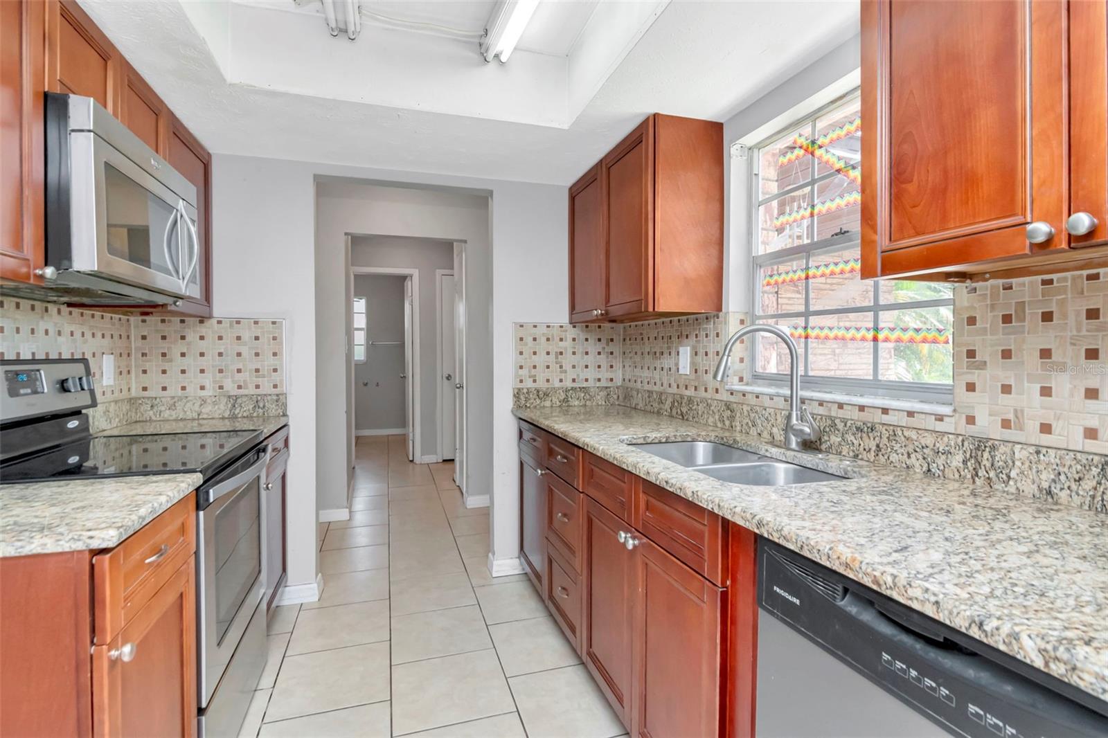 From the kitchen, looking towards the foyer, and the hallway to the two guest bedrooms, and the hall bathroom.