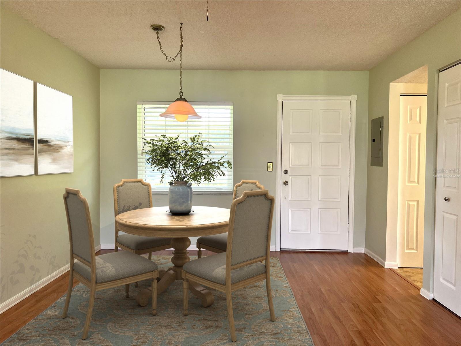 Virtually staged dining area shows you what is possible in this space.
