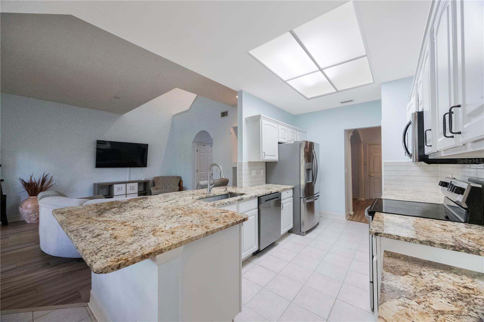 Kitchen has breakfast bar and room for a table
