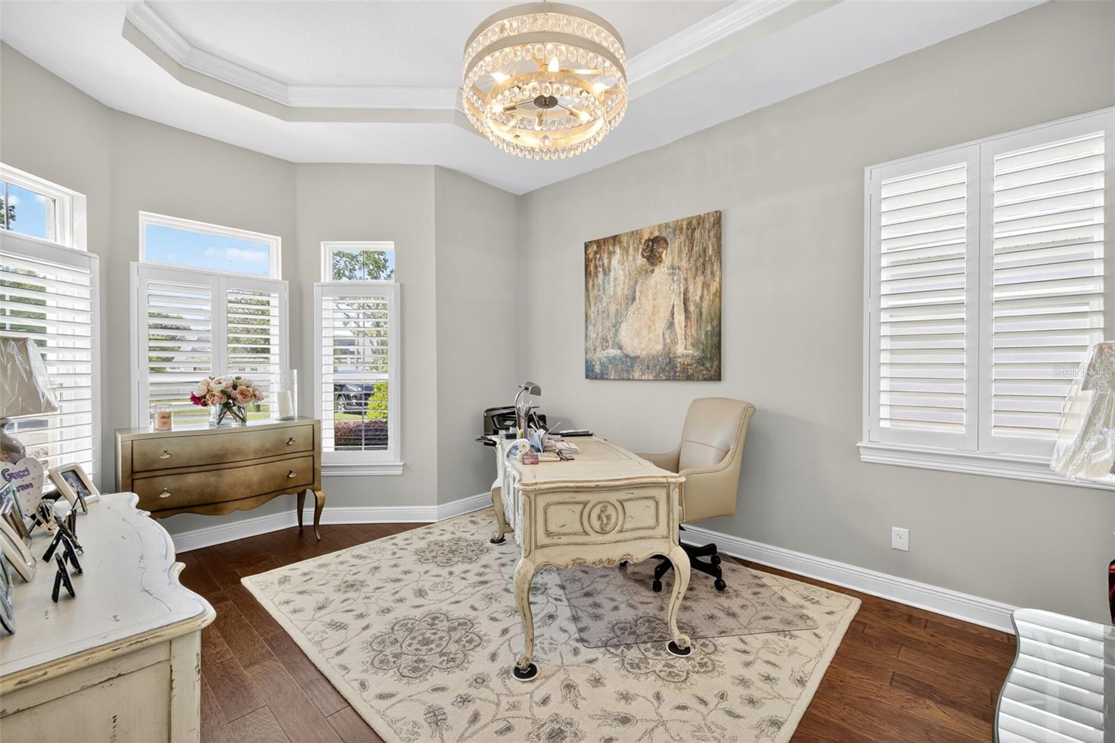 Bedroom 4 with French doors, chandelier and bay windows set up as luxury office