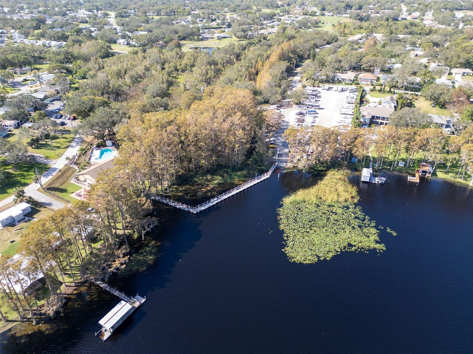 TWO PONTOON BOATS FERRY RESIDENTS TO A LOCAL WATERFRONT RESTAURANT