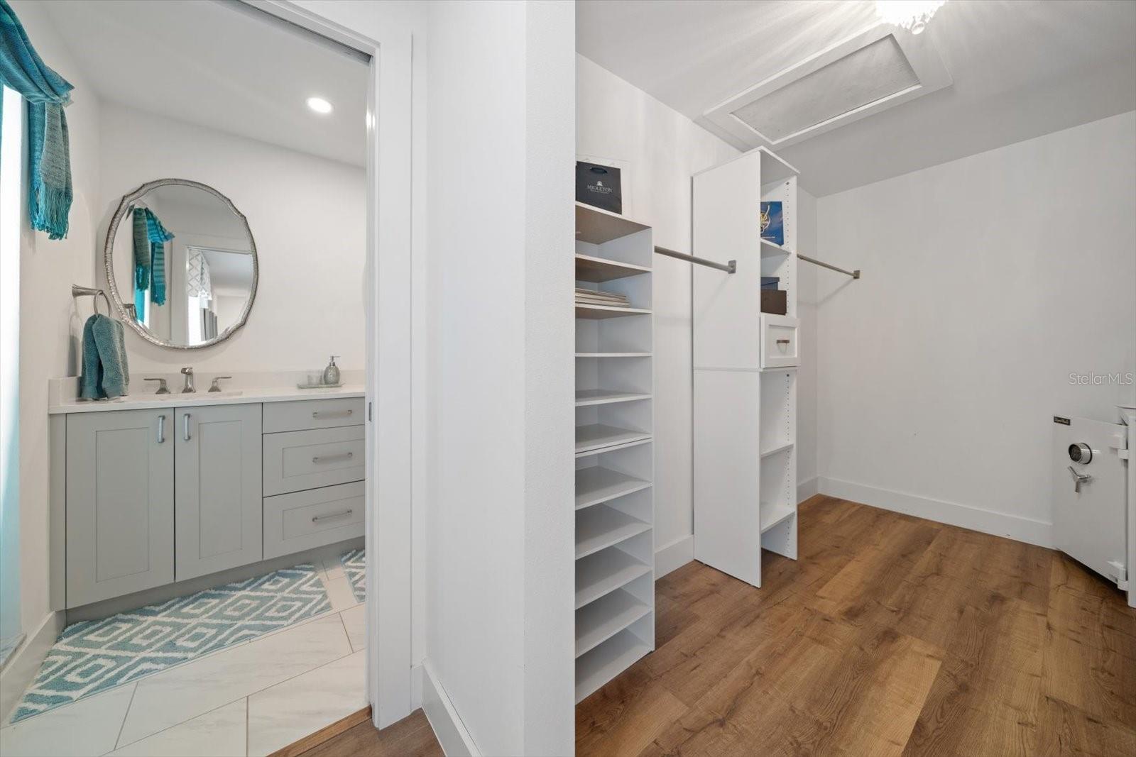 Walk in closet with built ins in primary bedroom