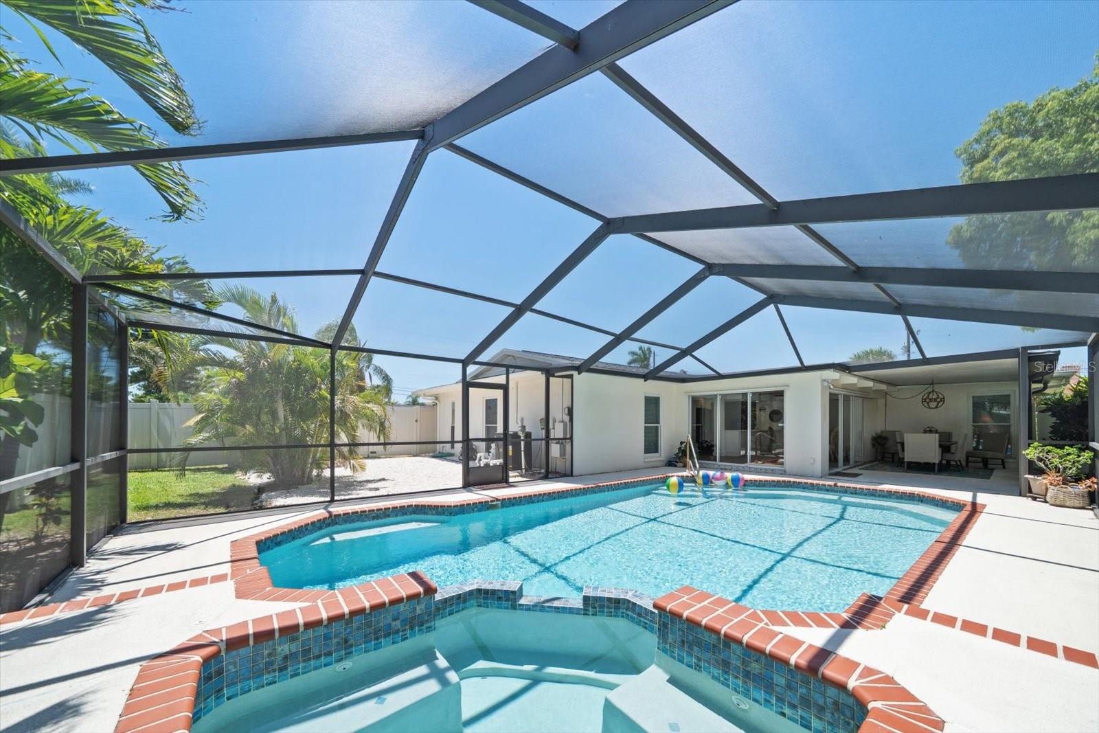 New screening of pool area provides additional area to enjoy! Lots of side yard too!