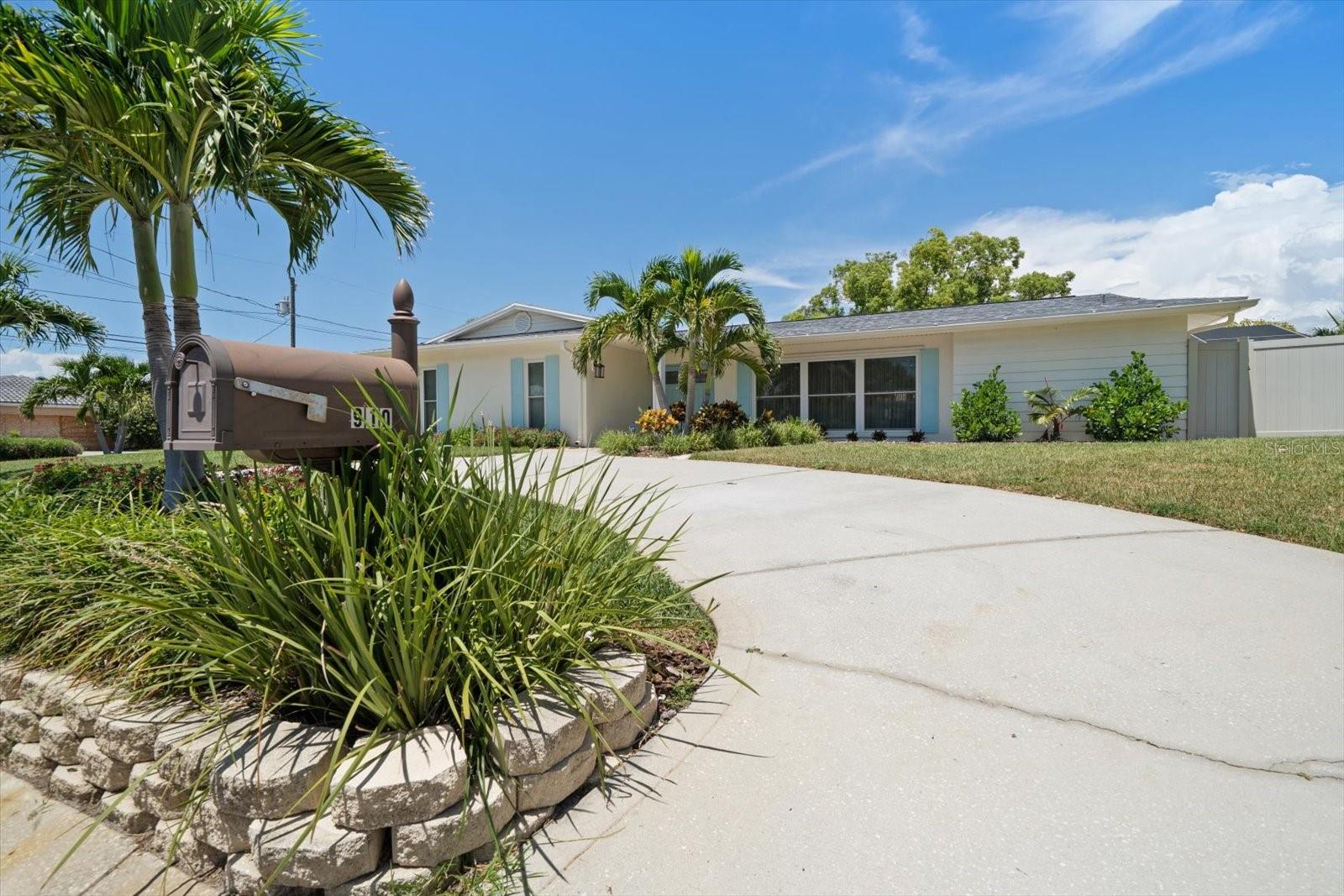 Approached by a circular drive, appreciate the lovely lawn and lush landscaping.