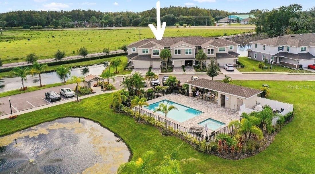 Aerial view from pool with home designated by arrow