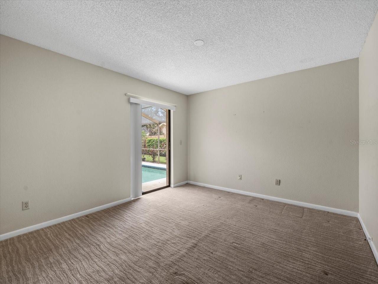 Bedroom 2 w/ door to Pool