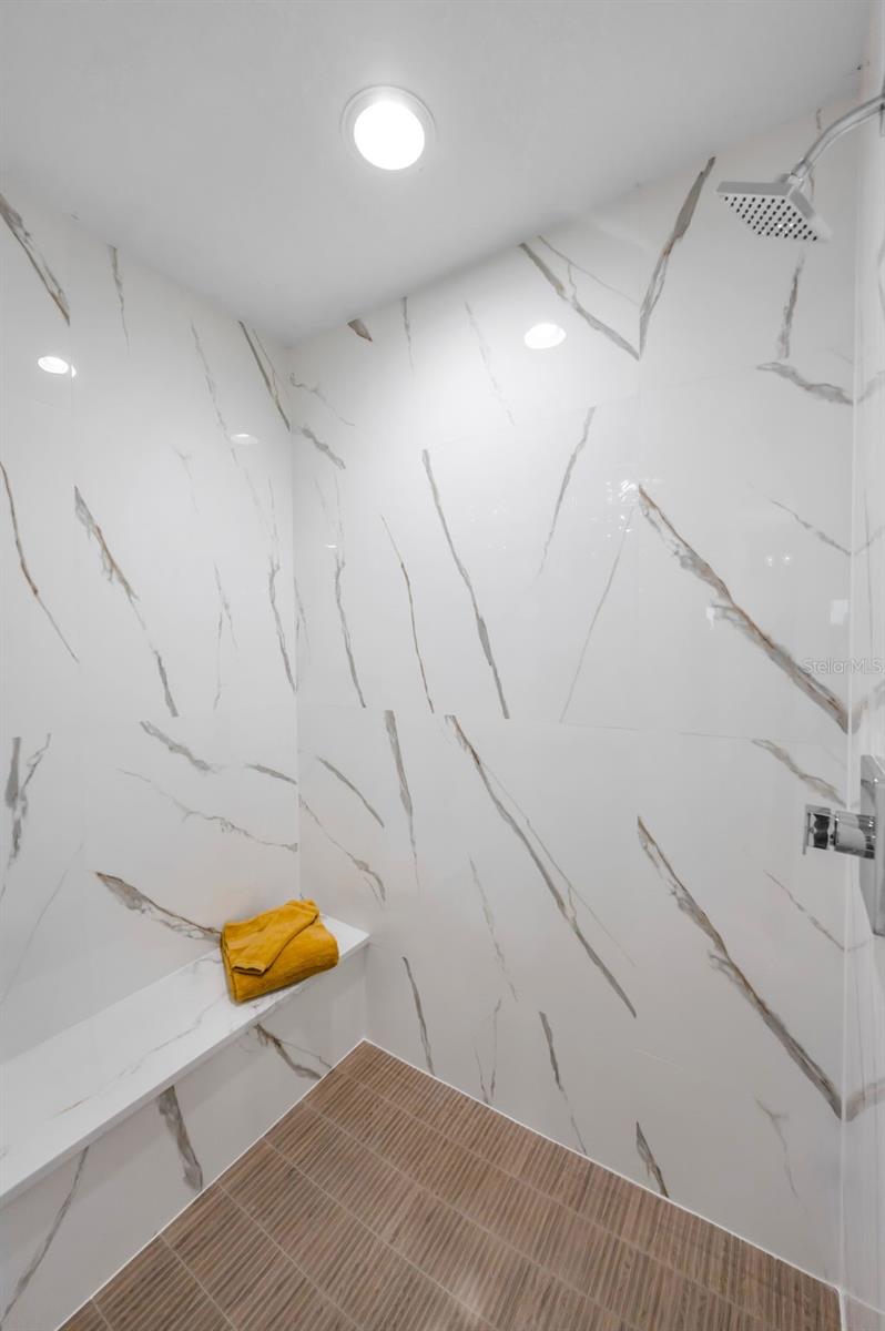 .. TIGHT SHOT OF REMODELED WALK IN SHOWER - SICILIA II POLISHED PORCELAIN TILE.