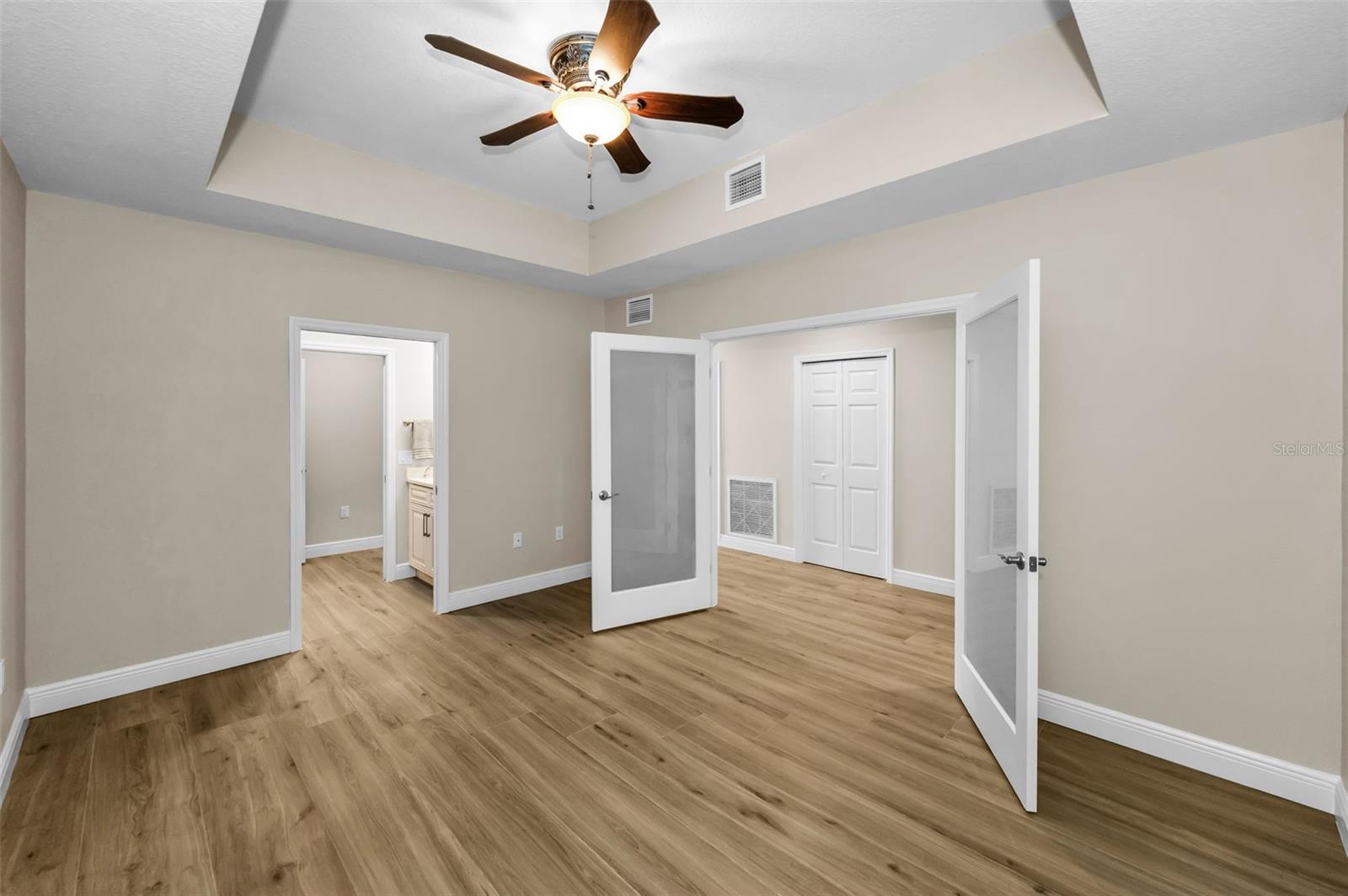 12-by-15-foot flex room/home office/media room that can be easily made into a 4th Bedroom if needed. Room has a remodeled 1/2 Bath with Sink & Commode Thru door.  Frosted Glass on Parlor Doors Which Open to Hallway.. Six Panel White Door in Hallway is Storage Closet. Laundry Room to Left of Six Panel Door.