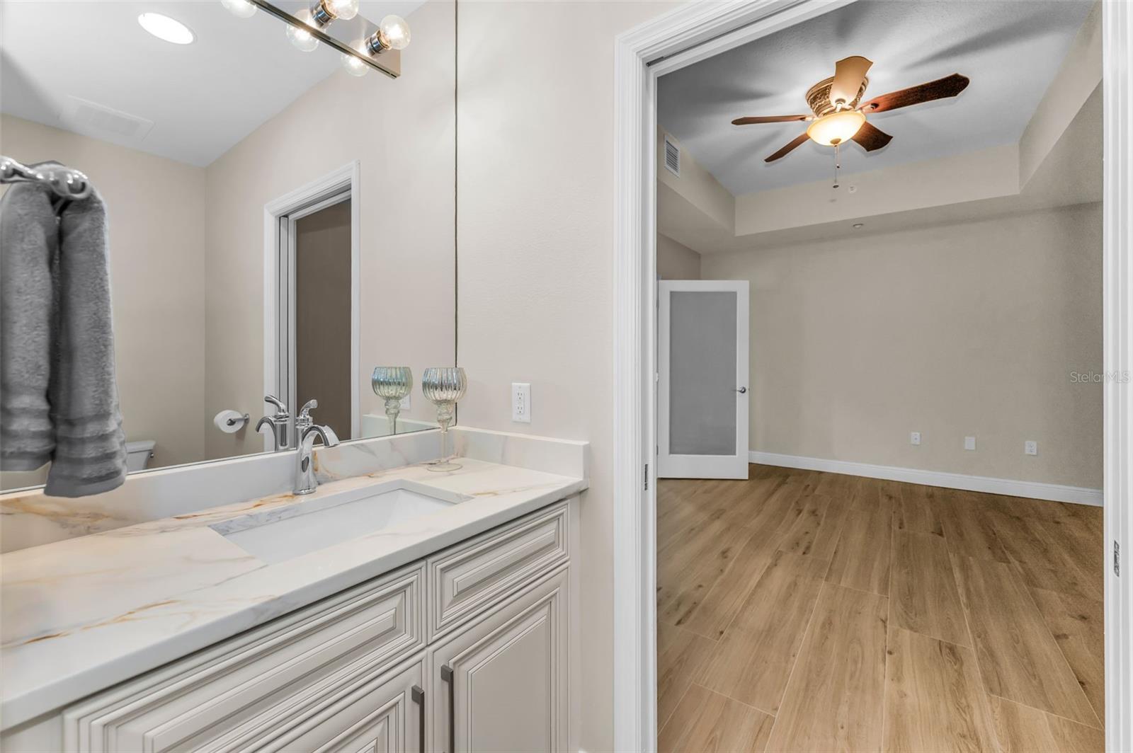 12-by-15-foot flex room/home office/media room that can be easily made into a 4th Bedroom if needed. Room has a remodeled 1/2 Bath with new Sink & Commode. This Half Bath Has Doors to Hallway & Flex Room.