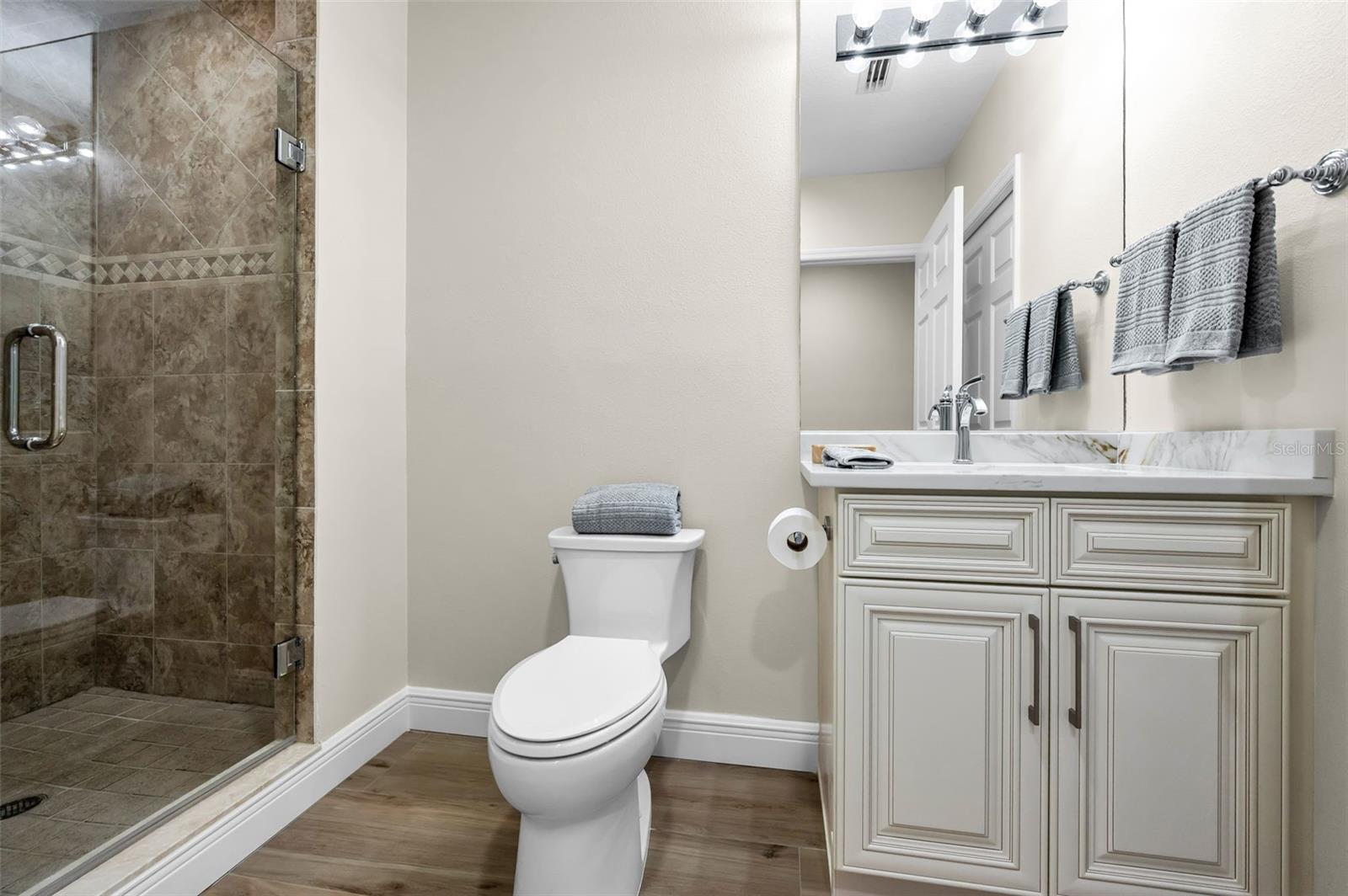 ..Bathroom #2 .. Feeds Both the Guest Bedroom and The Common Area. NOTE: Mirror Shows Door to Guest Bedroom. There is also a Hallway Door where Photographer is Standing. All Toilets in Residence #202 are New.