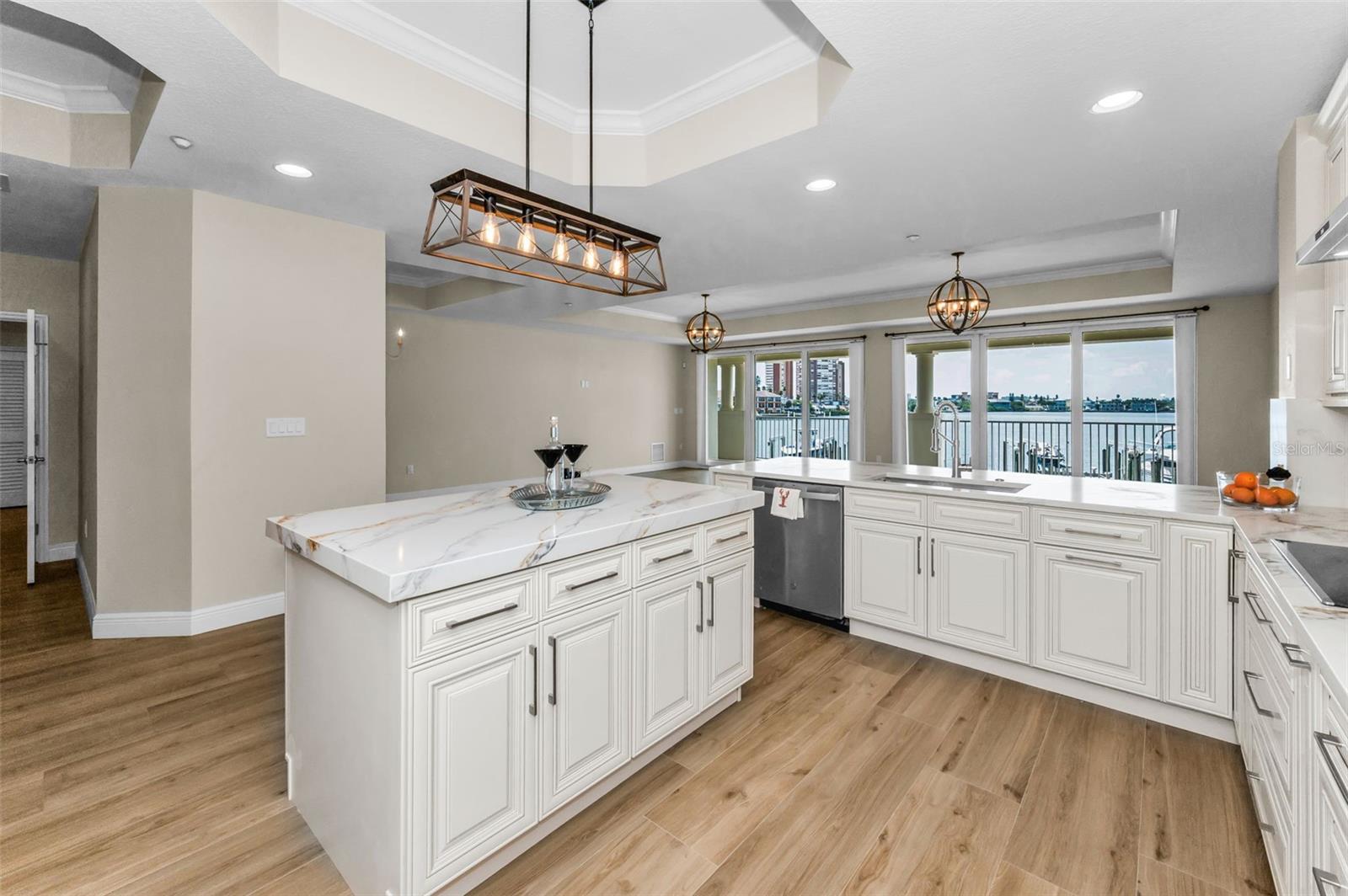 ..10 x 15' 11" New Kitchen Looking  Towards 30 Foot Wide Floor to Ceiling Balcony Sliders Opening to Paradise. Kitchen Features - Cumberland Pearl Custom Cabinetry - Solid Wood - Soft Close..  Counter Tops & Back Splash - Tivoli Sunrise Quartzite  Level 5 With Mitered Edge.
