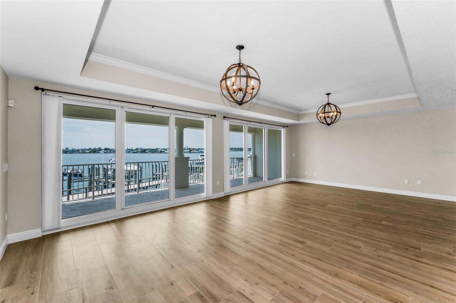 ..New Woodville Natural Wood Plank Porcelain Tile . ..Shot From In side Unit Looking Out Onto Your 45 Foot Ling Balcony.. The Great room is Fronted By 30 Feet of The Balcony. The Master Suite to The Left enjoys another 15 Feet of Balcony . You Have a total of About 45 Feet in a Continuous Run of Water Views From The Balcony.
