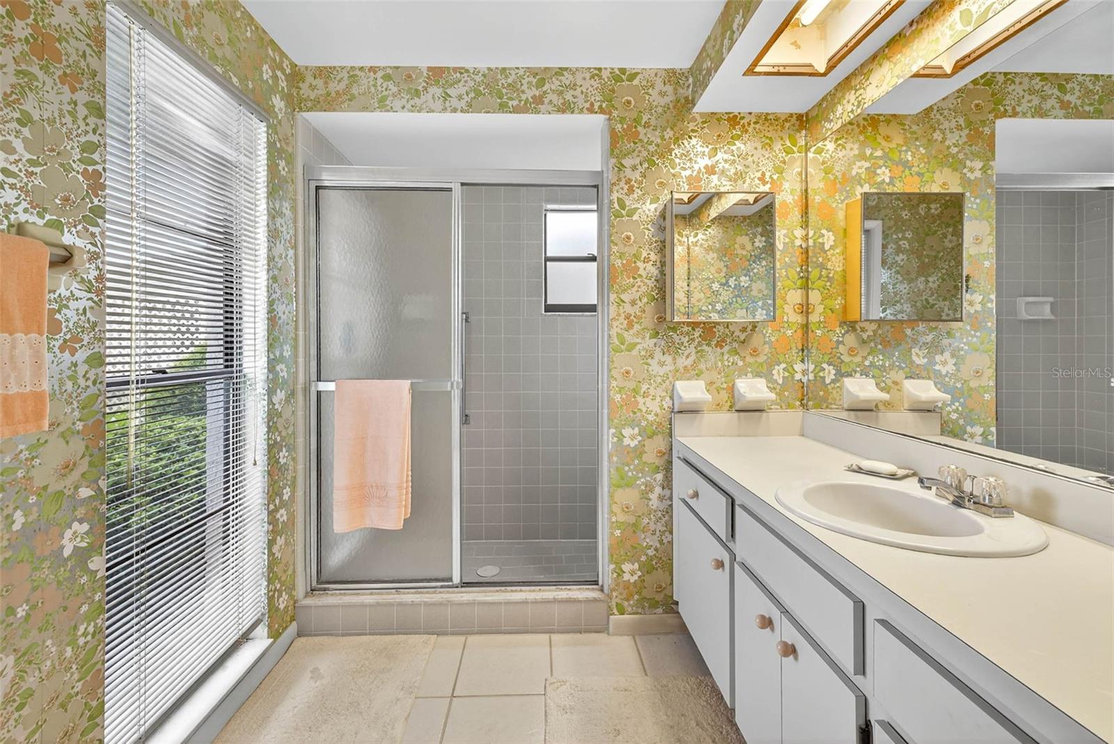 primary suite with shower and bench inside
