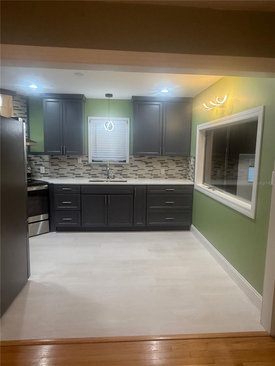 Fully remodeled kitchen with south facing window overlooking beautiful backyard