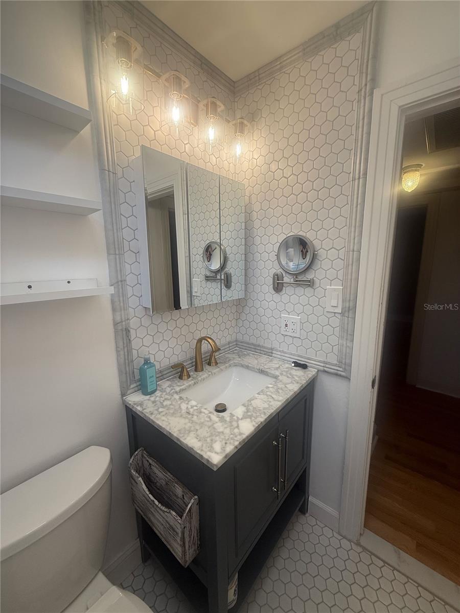 Completely renovated bathroom with mounted makeup mirror