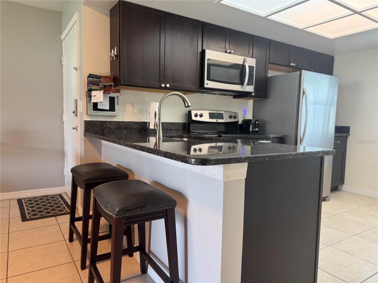 Kitchen with granite countertops and loads of storage!