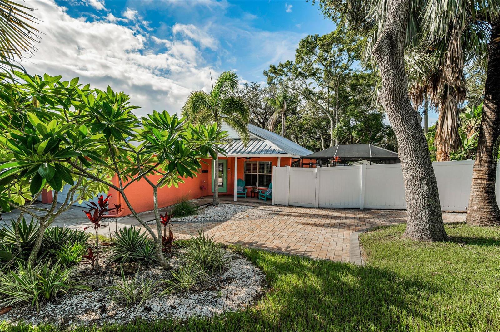 Lush, tropical yard with mature blooming foliage