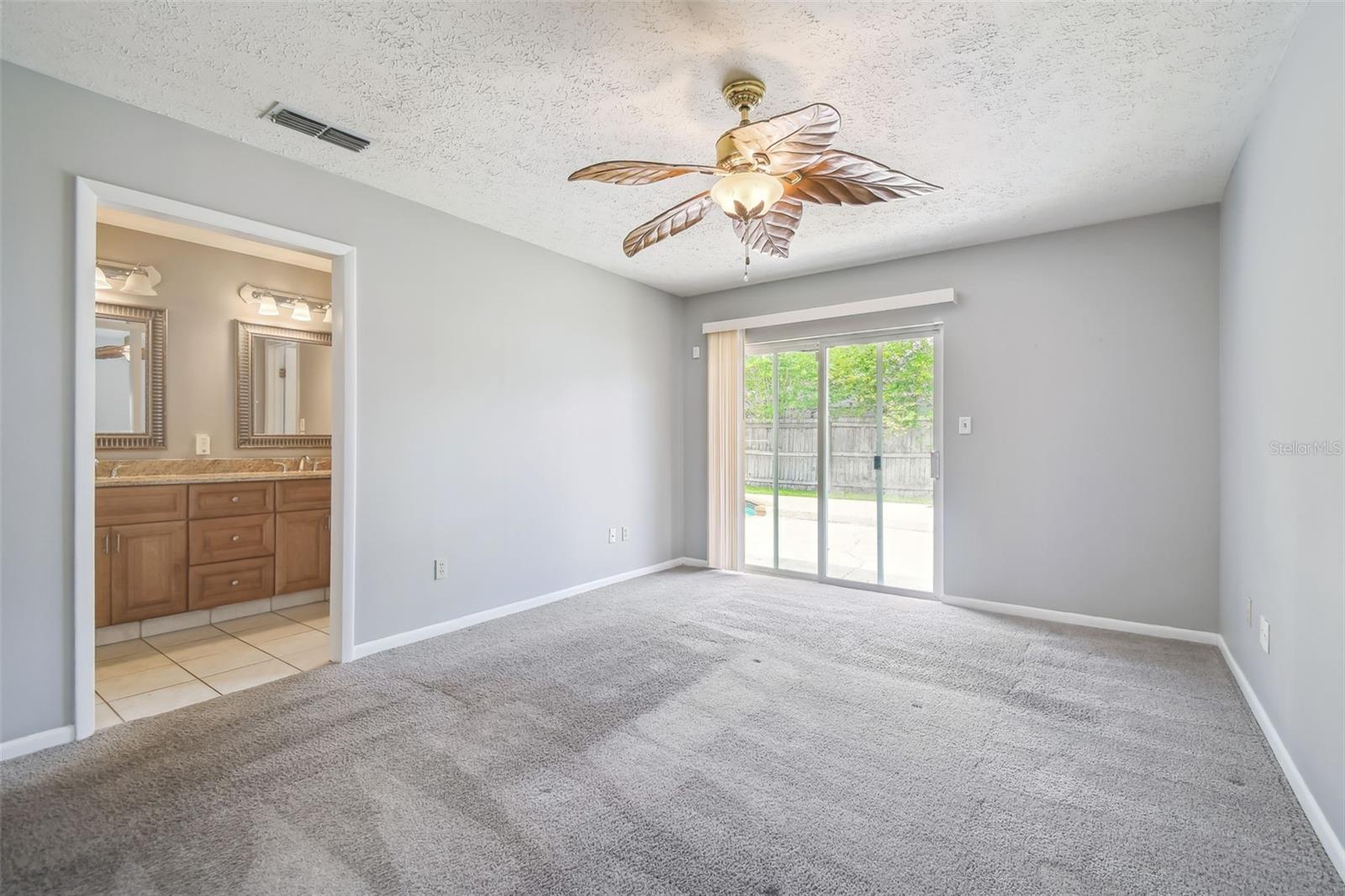 Primary Bedroom w/sliders to the backyard & en-suite bathroom