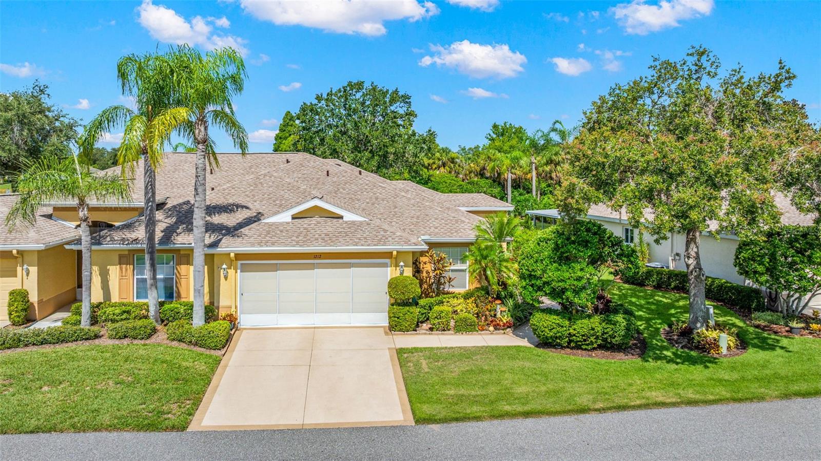 2-car garage with sliding garage screens and side entrance to home