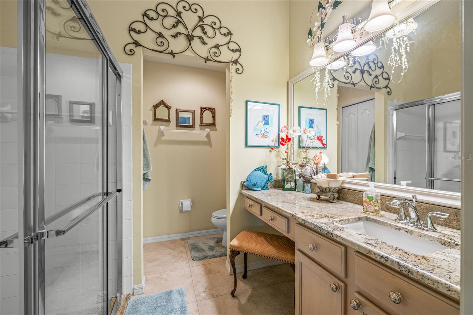 Primary bath with step-in shower, single vanity with granite countertops