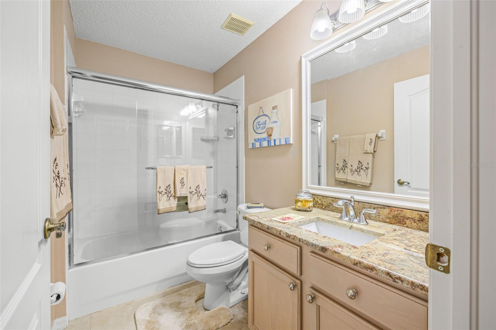 Guest Bathroom with granite countertops and tub/shower combo