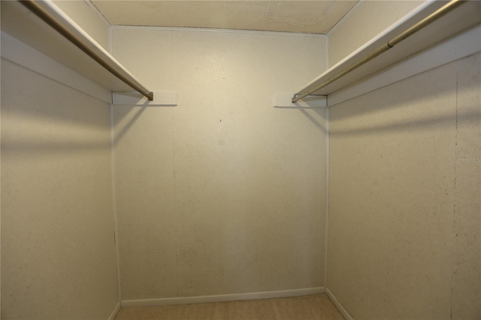 Walk in closet in primary bedroom.