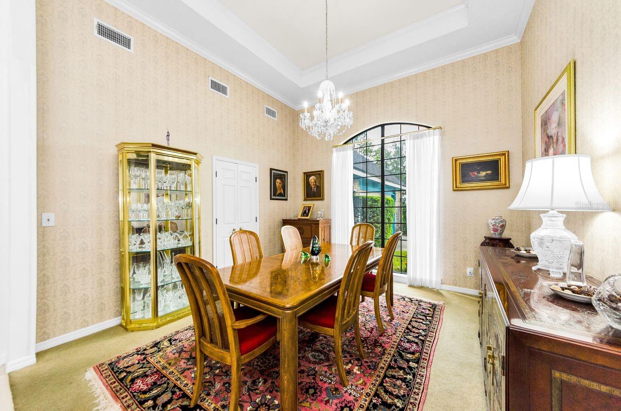 Elegant dining room with French doors to the back hallway and butler's pantry.