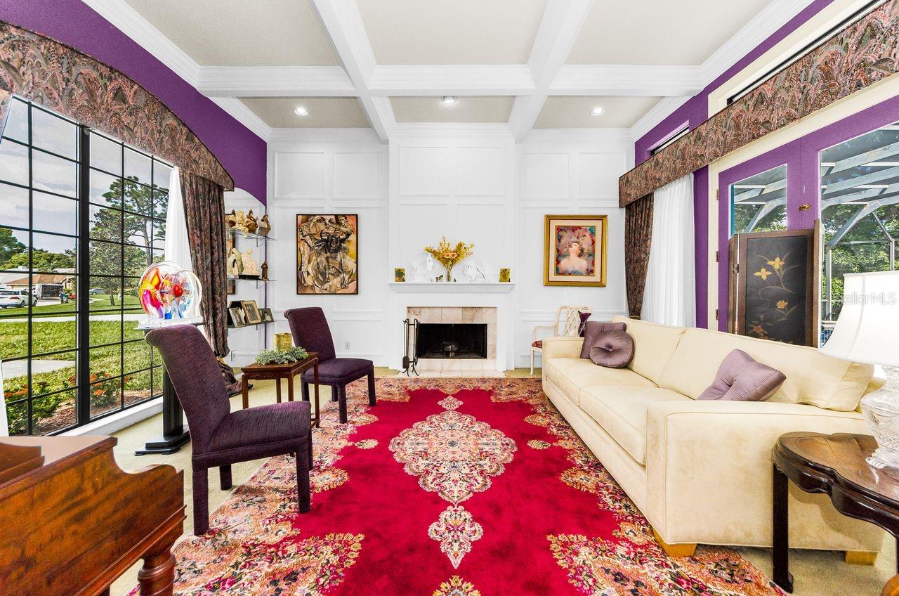 Elegant living room with coffered ceiling and views to the front and pool and spa, lanai.