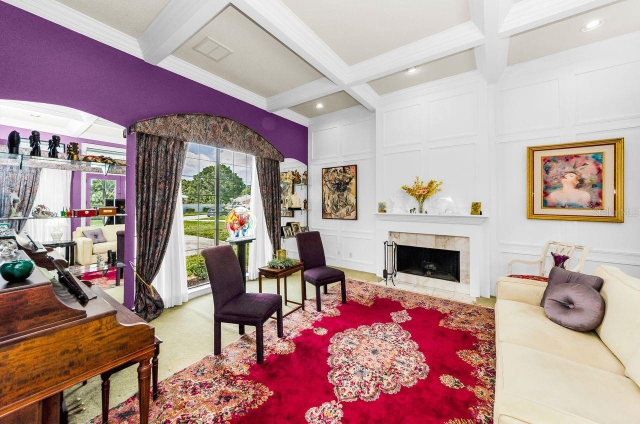 Wainscoting and a traditional fireplace and mantle make this a wonderful room!
