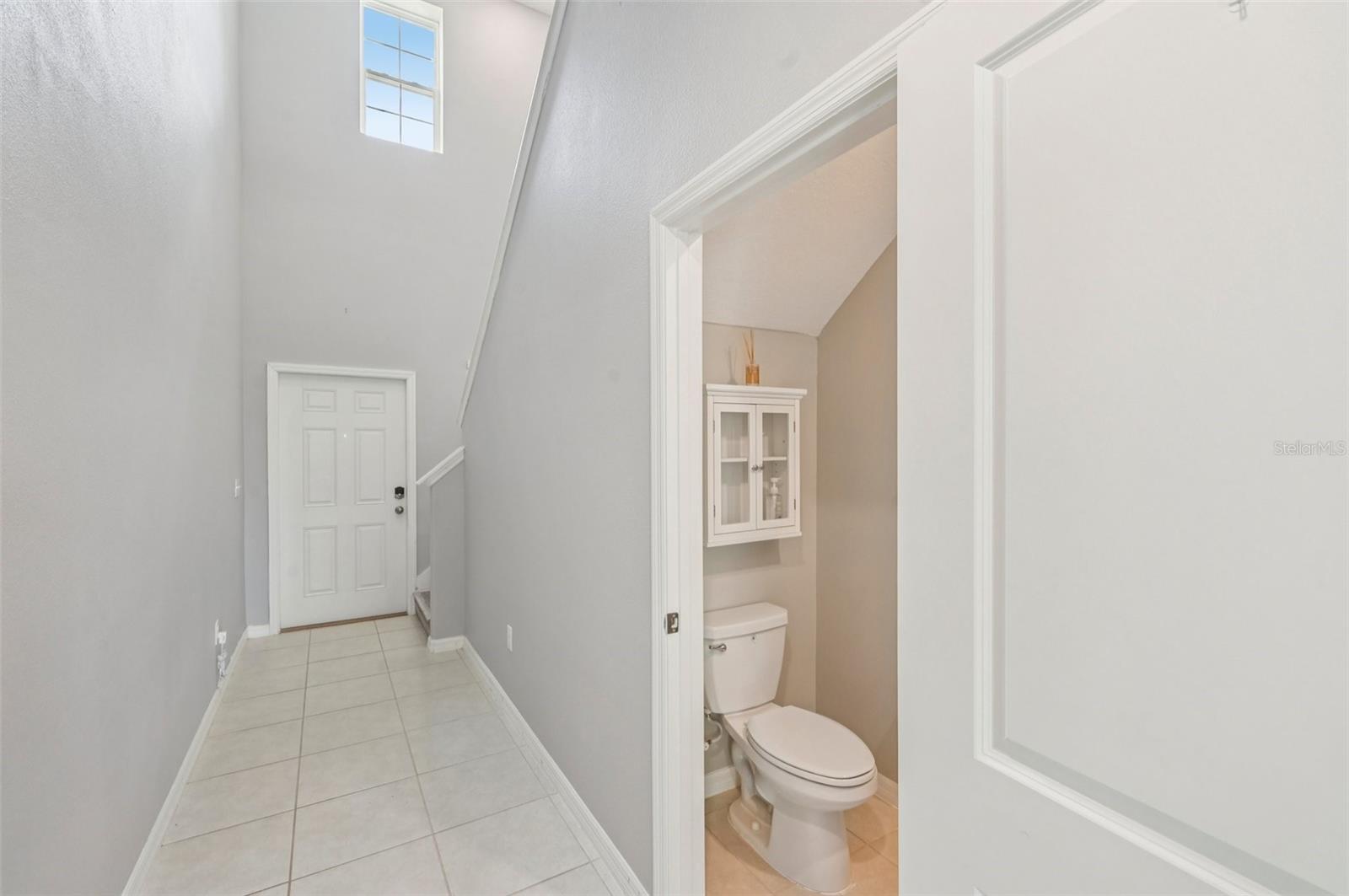 Home Entry Hall and Half Bath Leads to Upstairs