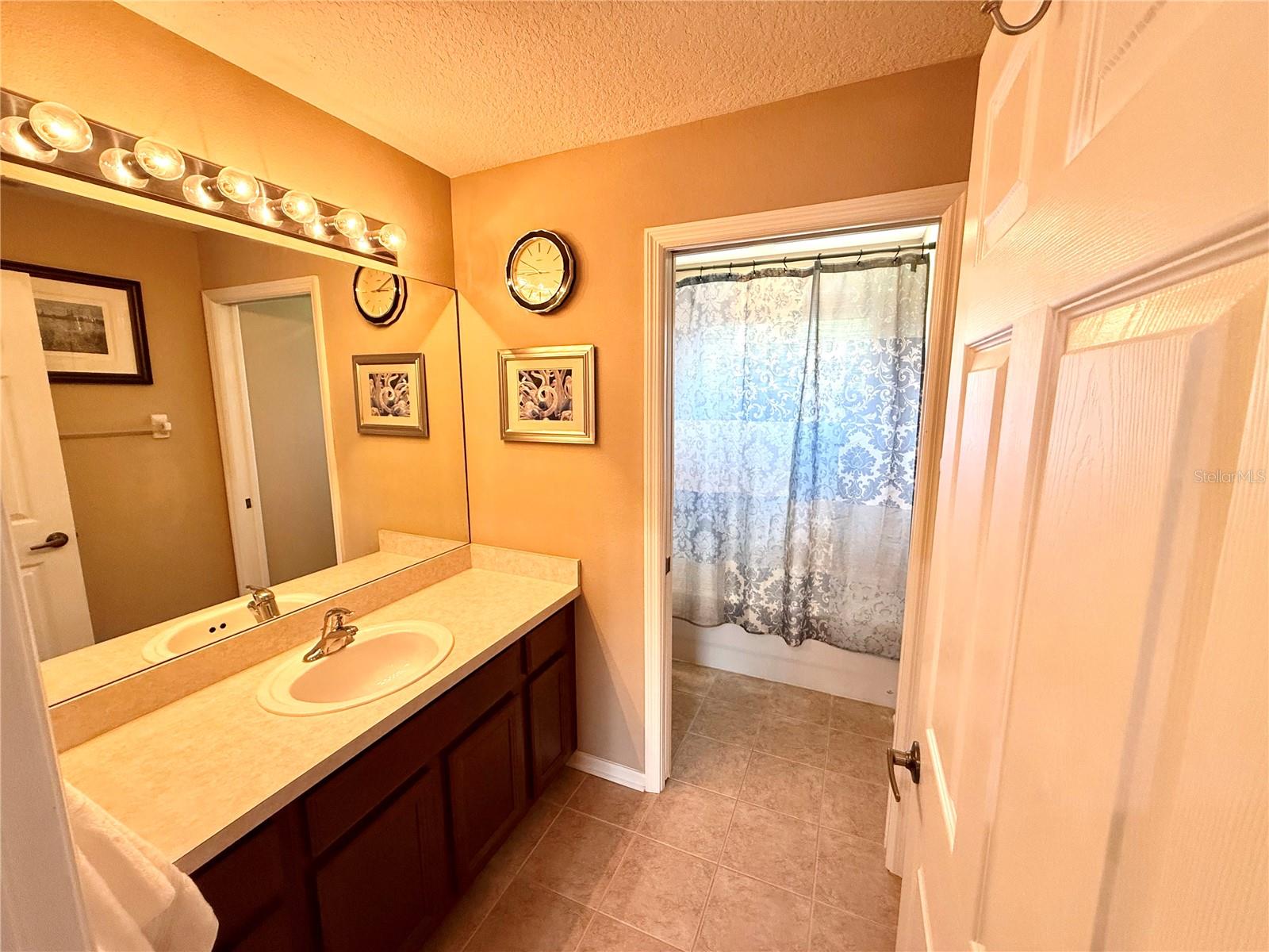 1 of 2 upstairs baths with separate sink area