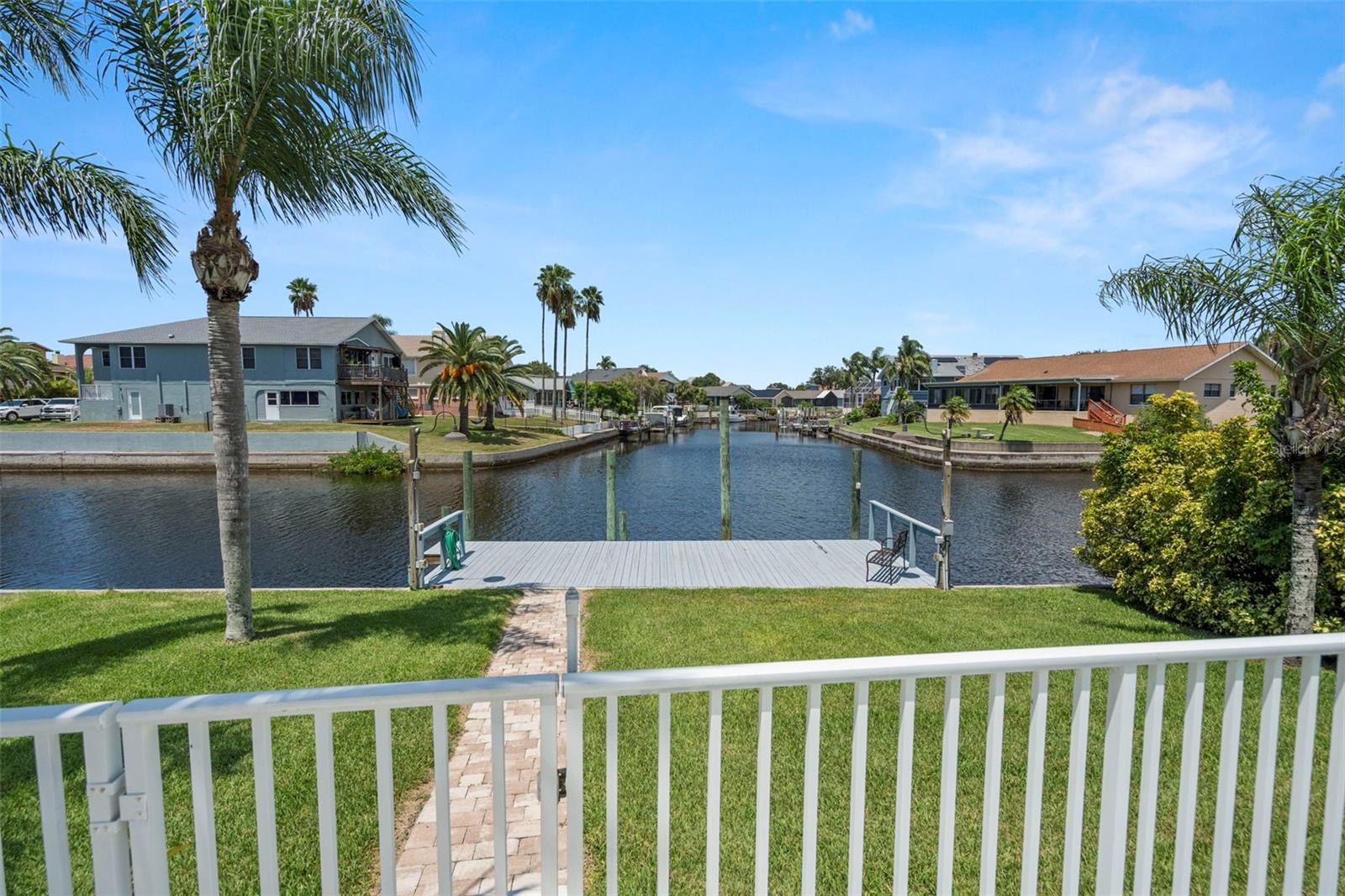 view of pool, dock from lower level lanai