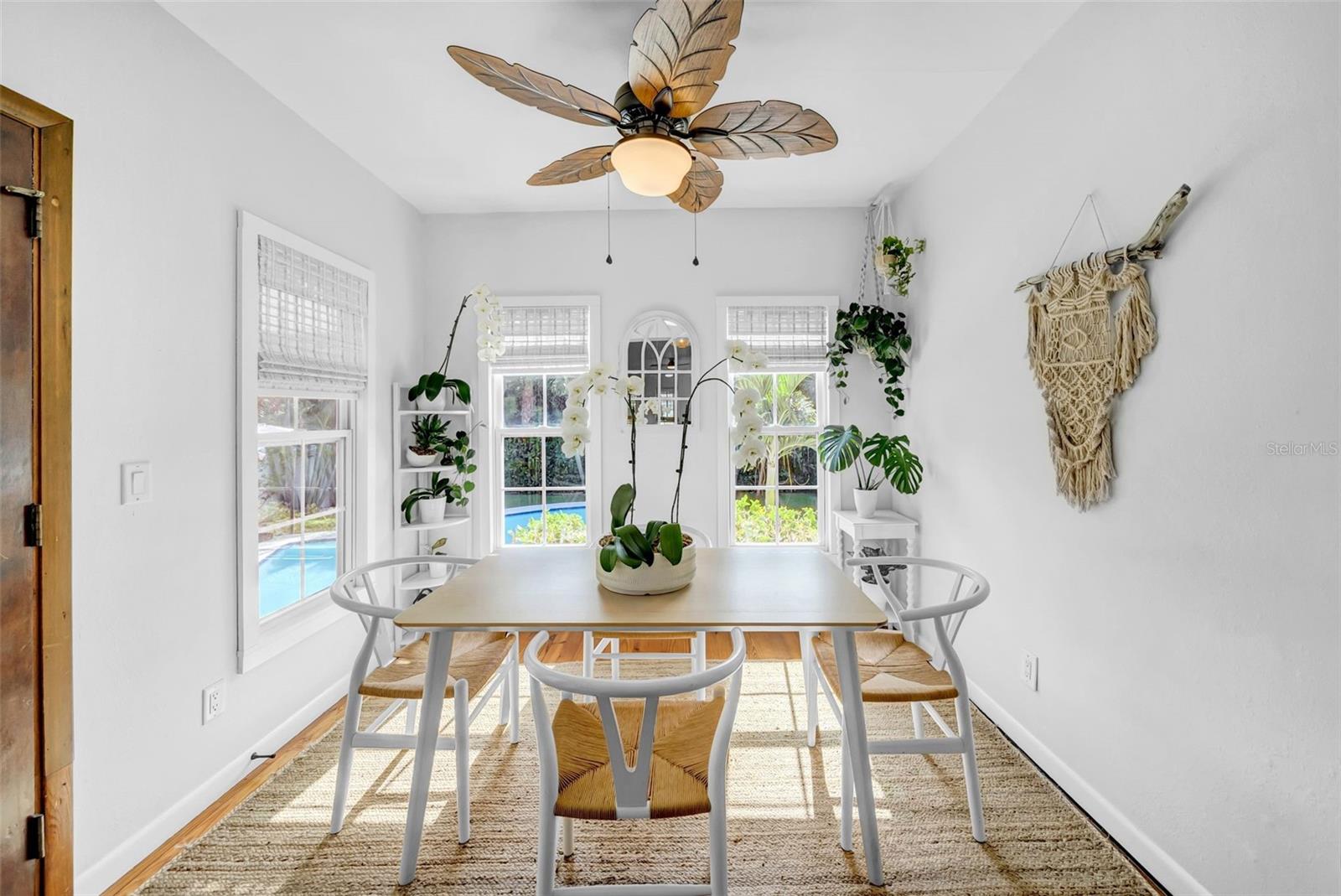 Separate dinging room with views of the tropical backyard.
