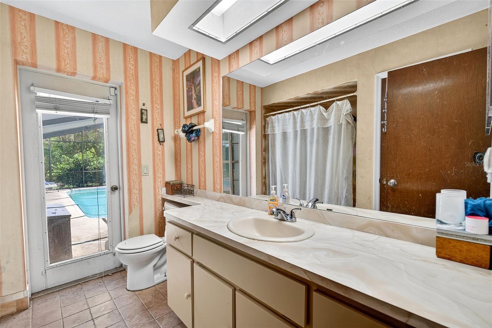 Guest bathroom with door to the pool area