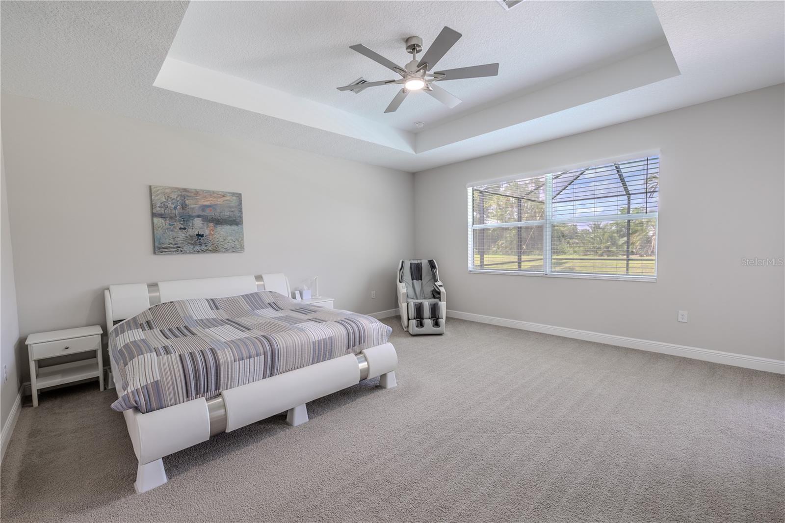 The generous layout of the primary bedroom provides ample space for a full bedroom set and seating area.