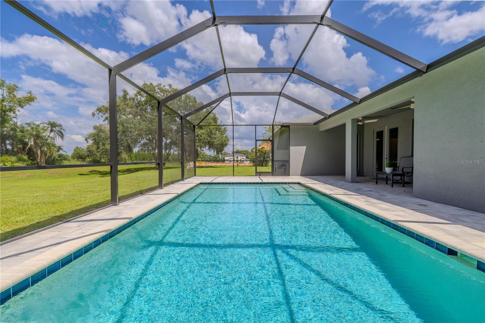 The pool is heated for year-round use and includes a pool alarm for added safety.