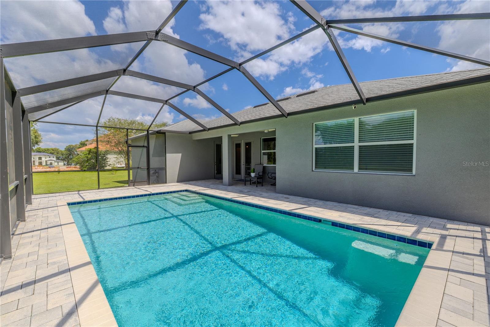 The pool is heated for year-round use and includes a pool alarm for added safety.
