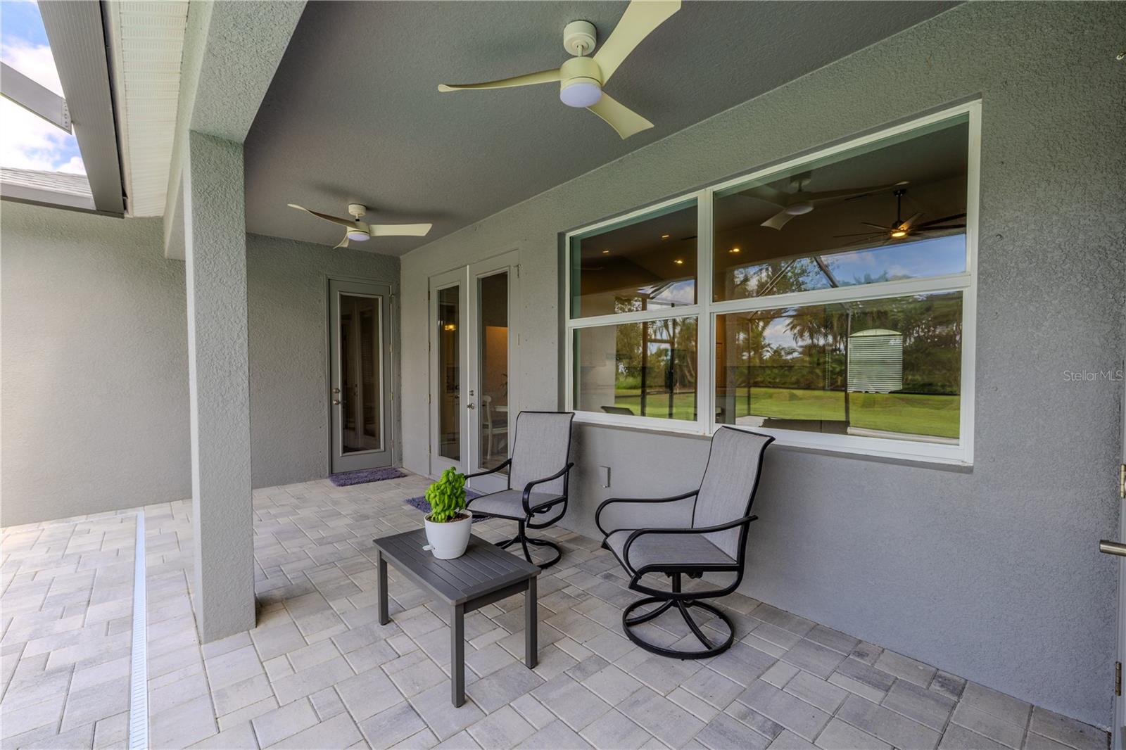 A covered patio with dual ceiling fans provides year round enjoyment