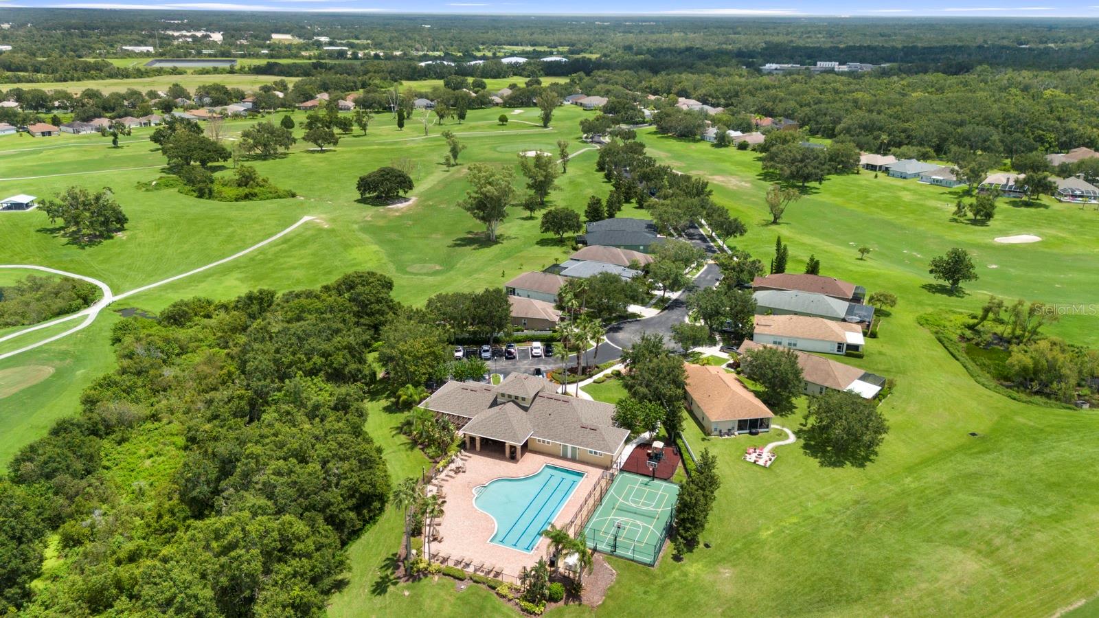 Aerial view of community clubhouse, pool, basketball courts