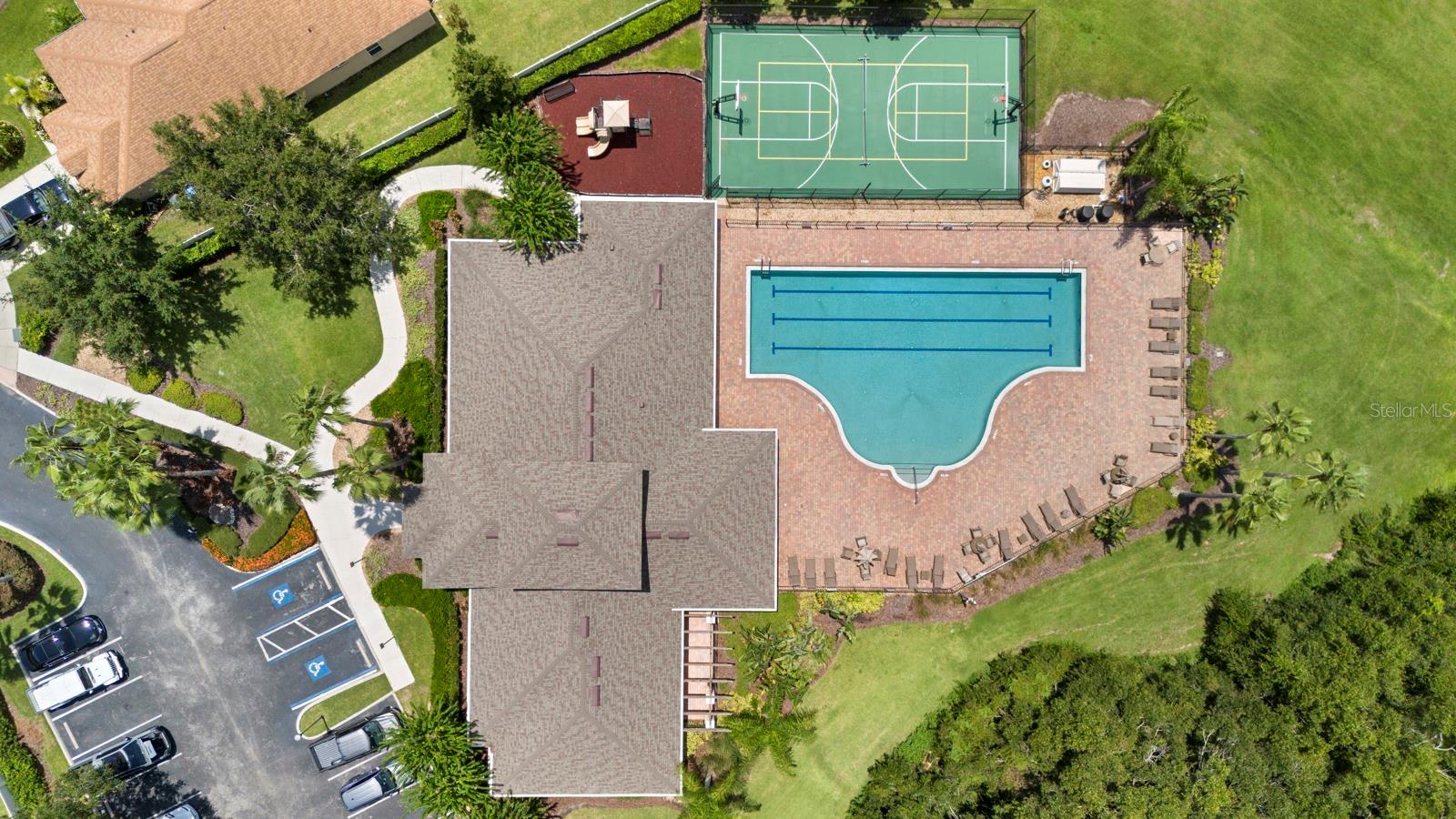 Aerial view of community clubhouse, pool, basketball courts