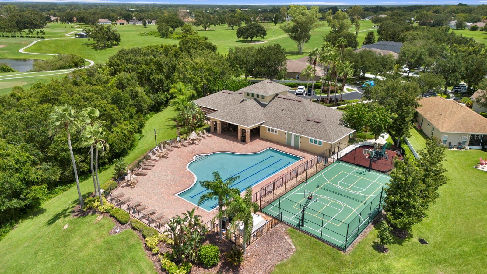 Aerial view of community clubhouse, pool, basketball court