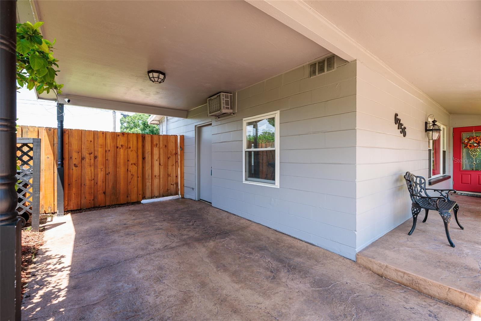 Carport w/ side entrance to den