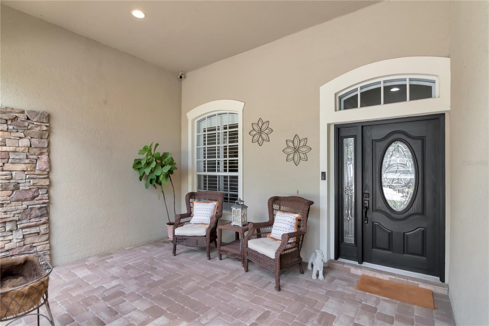 Covered and Pavered Front Porch Area with Enough Space for Seating/Lounge Area