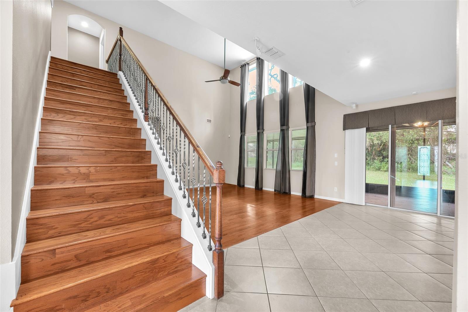 The family room with soaring two-story ceilings and an abundance of windows that flood the space with natural light.