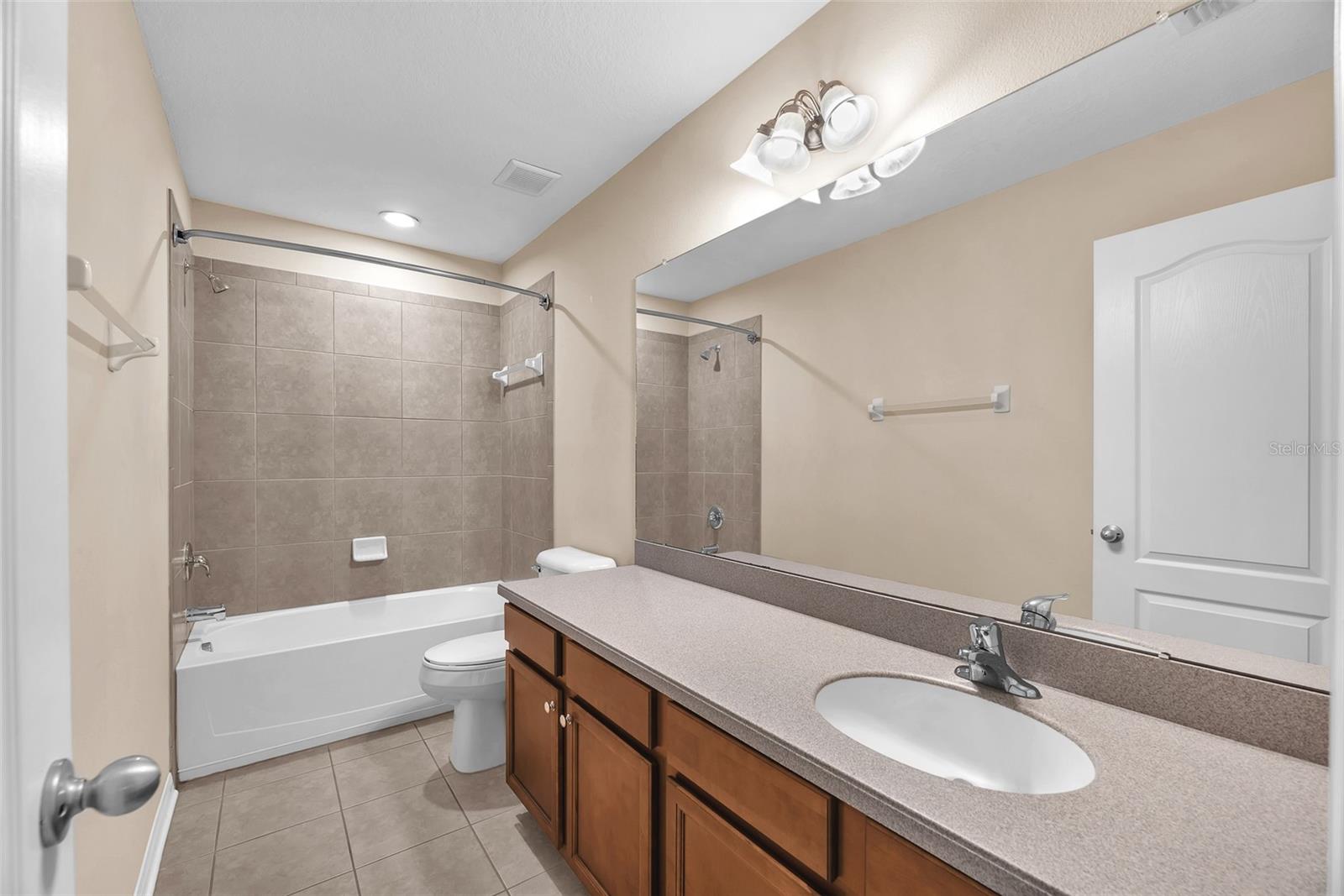 Full bathroom #3 upstairs shared by bedroom #3 and #4 has a tub/shower combination.