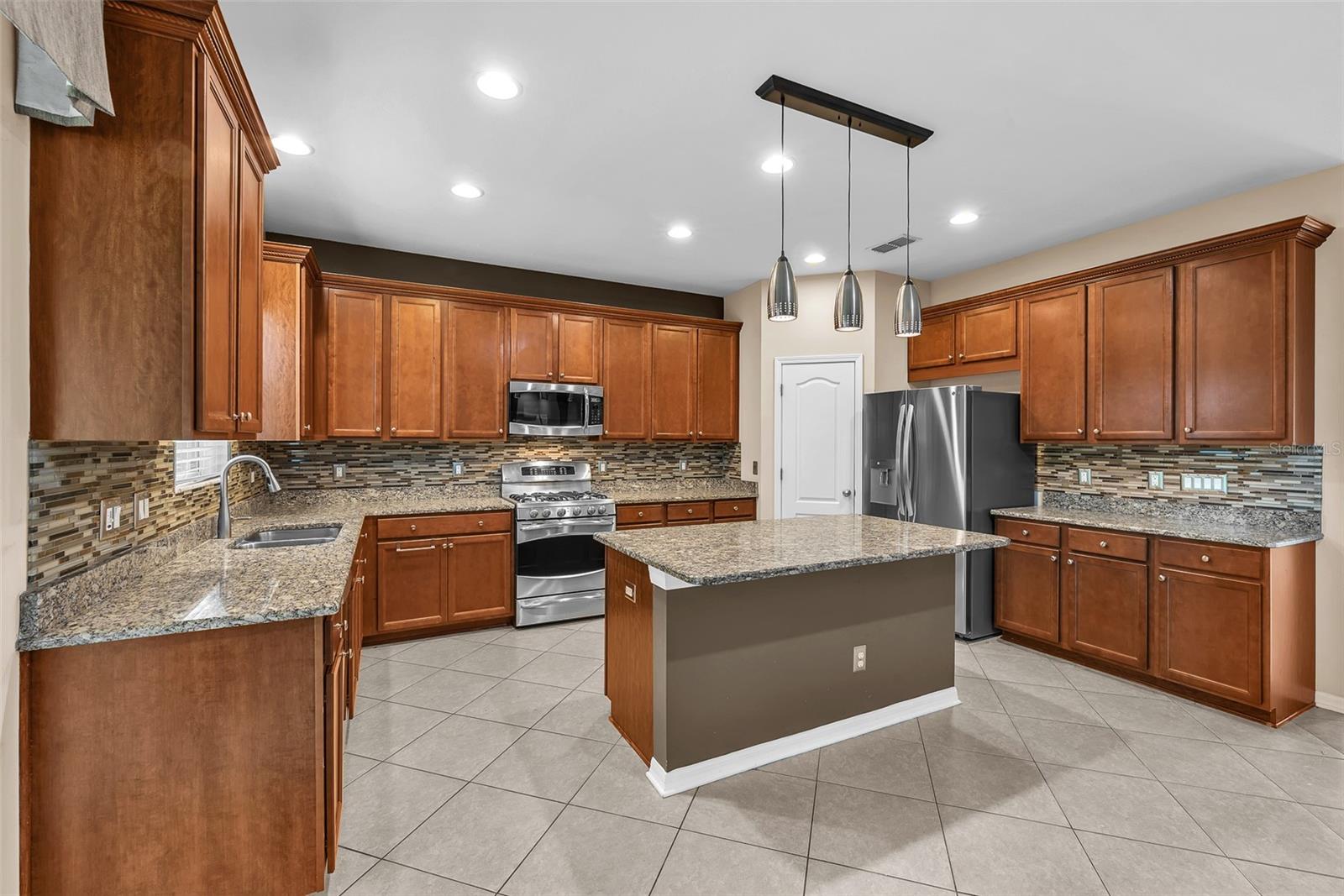 The kitchen island has storage and additional seating.