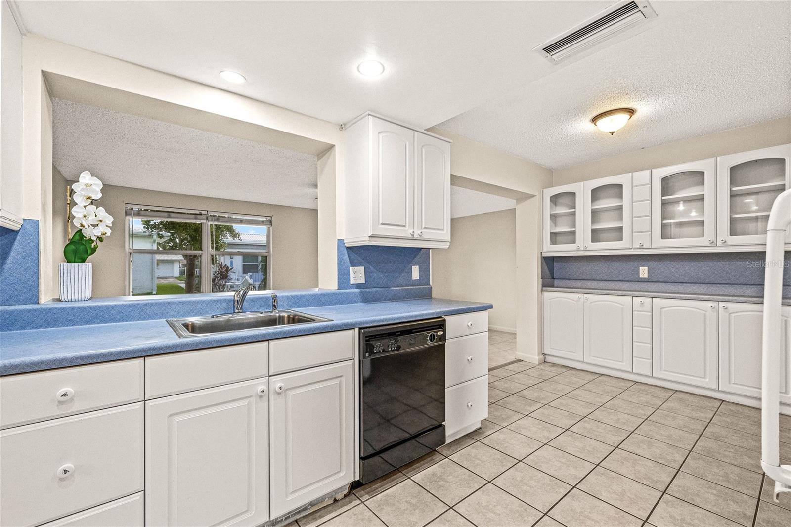 Kitchen opens up to the Florida room.