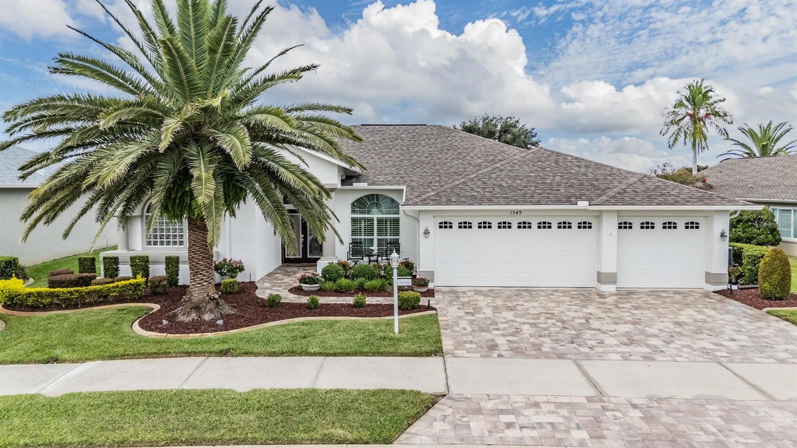 3 car garage with pavered driveway