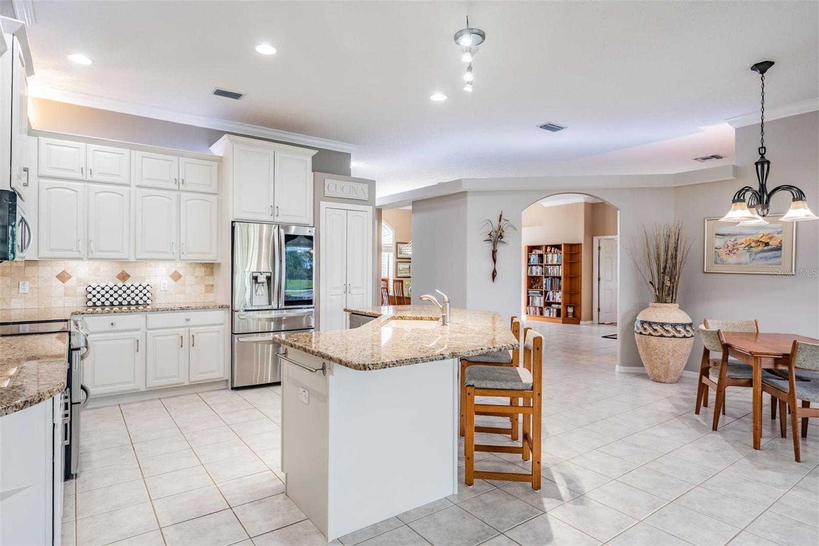 High ceilings with recessed lighting and easy-care tile